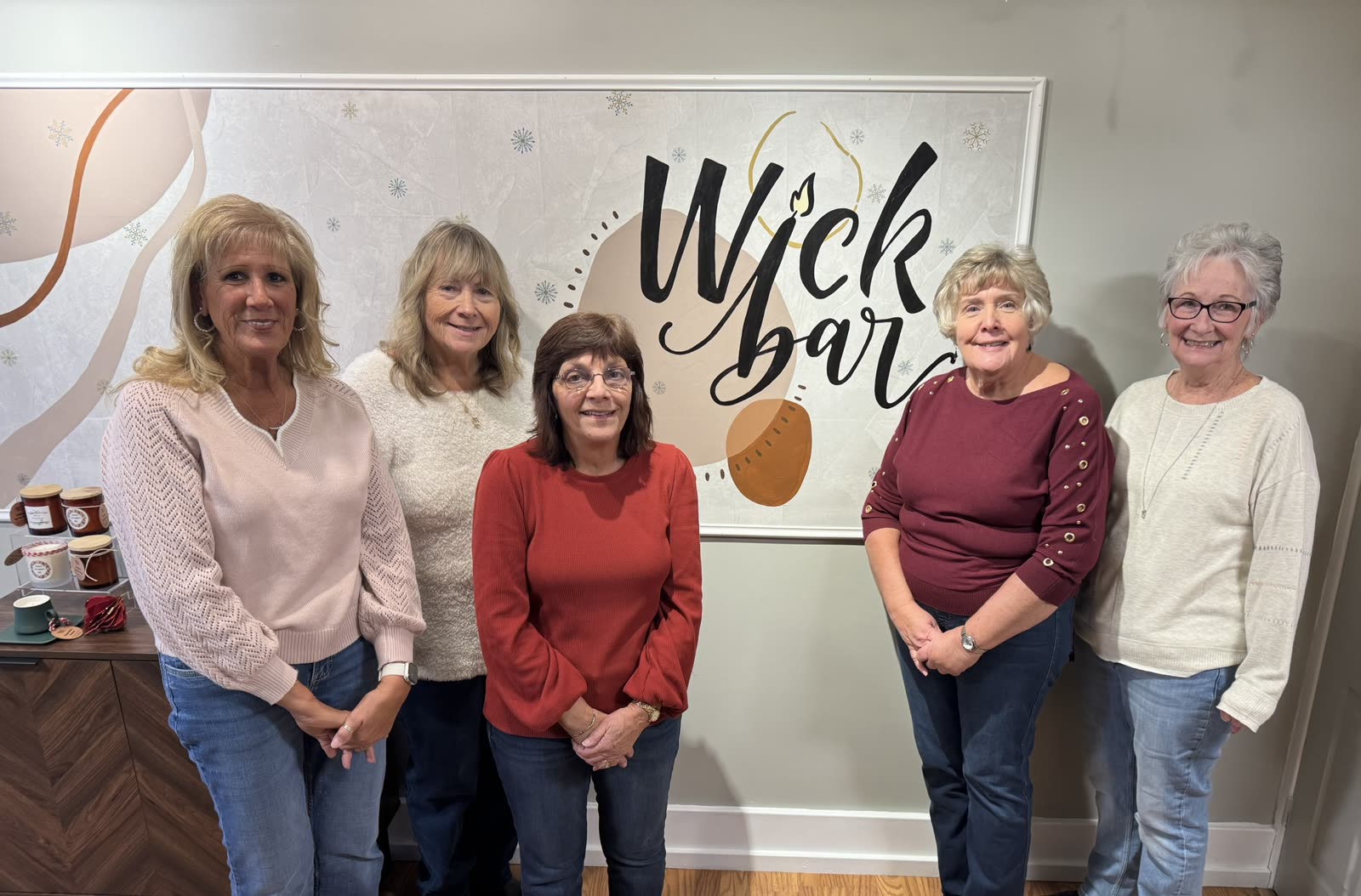 Five friends together under the Wick Bar sign after their class.
