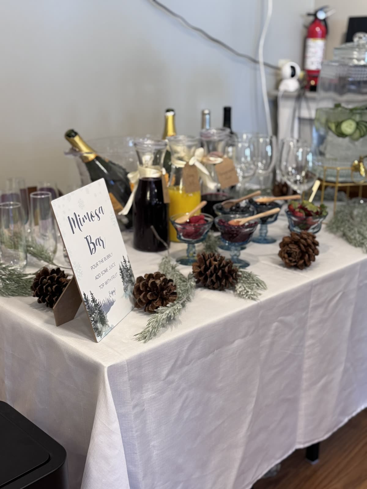A mimosa bar set up for a party at Wick Bar — bubbly, juices and fresh berries.